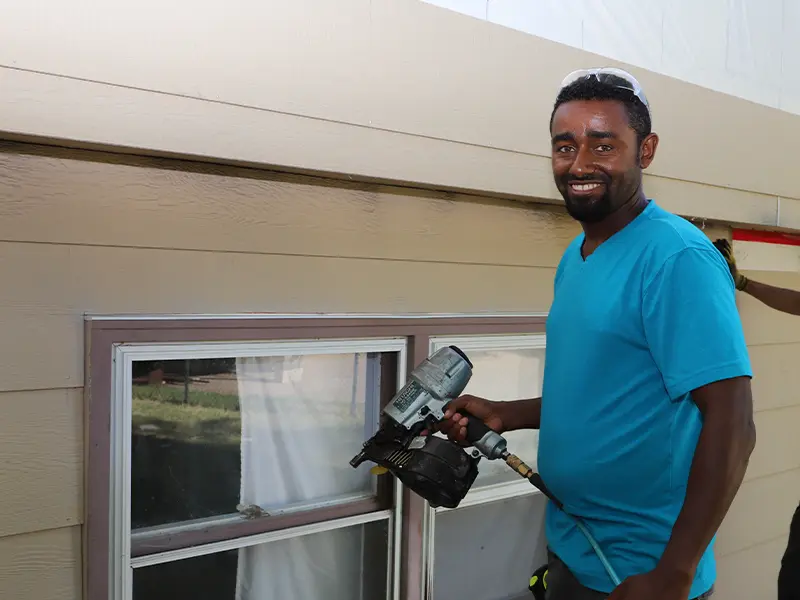 Family partner Andy is holding a nail gun.