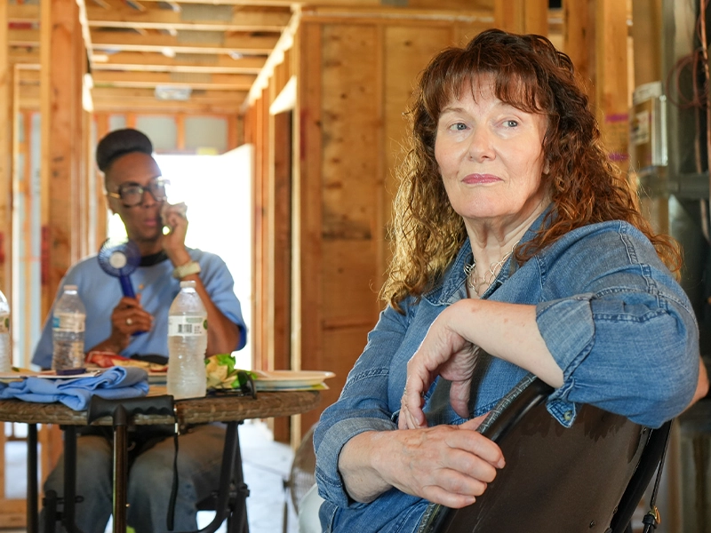 Two volunteers listening at a Legislative Build education session.