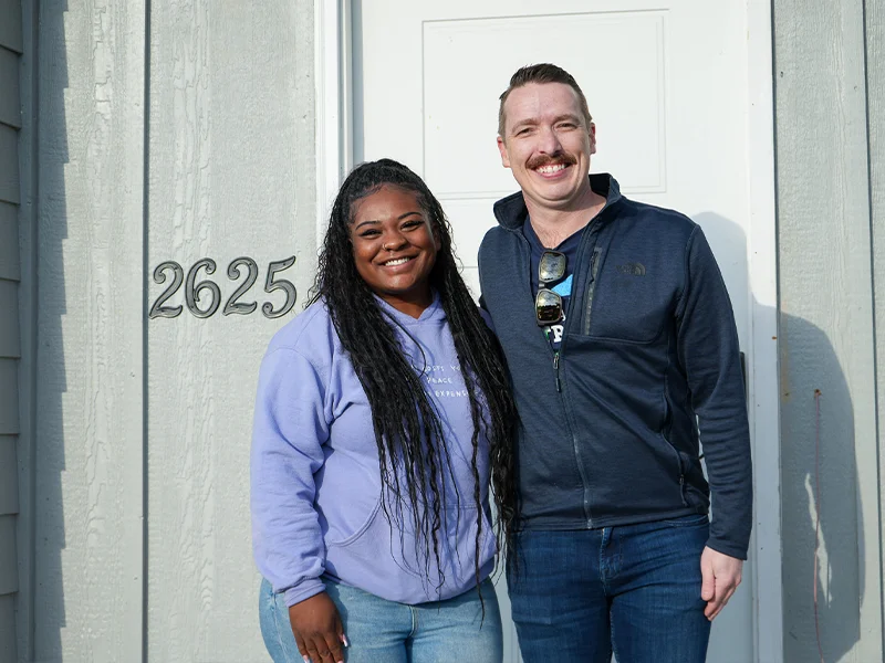 Family partner Victoria and Sam Chandler with the house numbers.