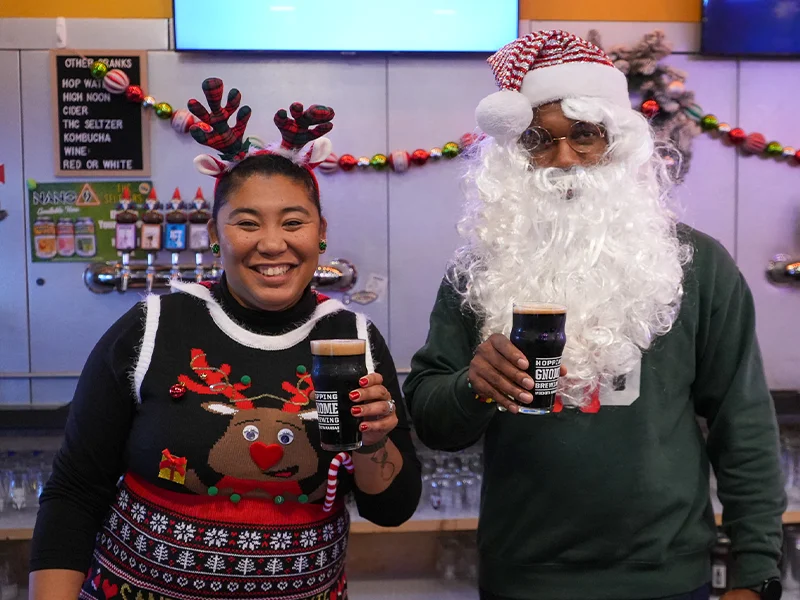 Danielle Johnson and Brandon Johnson holding glasses of beer.