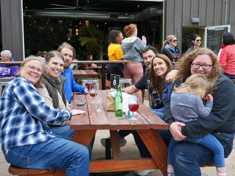 Habitat team and family members gathered around a table and smiling.