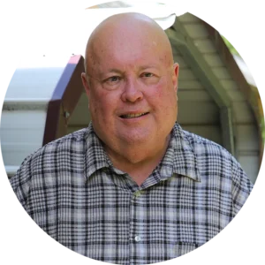 Home Repair applicant Jim stands on his new porch.