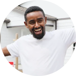 New homeowner Andy cheerfully standing in front of his home.